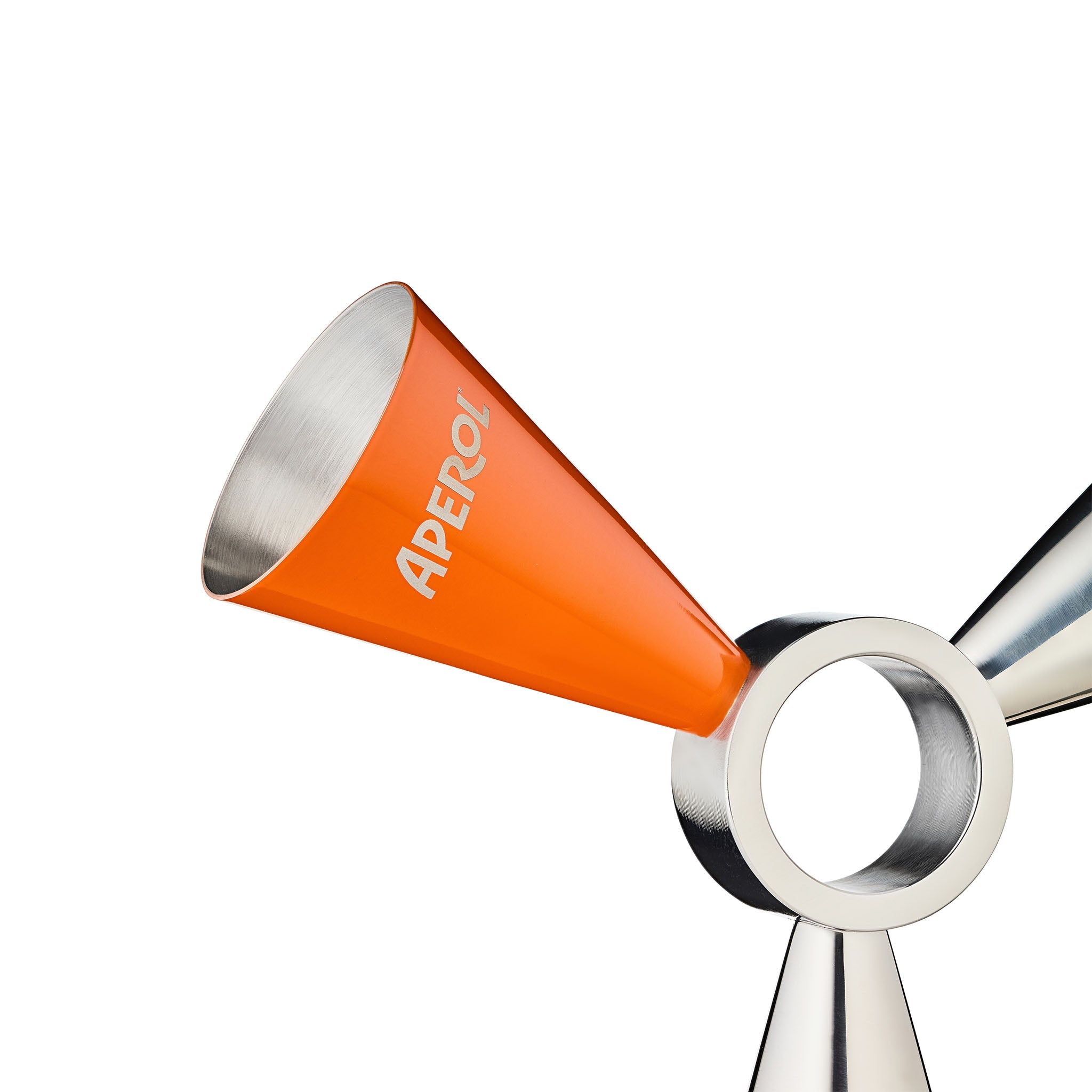 Close-up of a metallic drinks jigger with a bright orange cone-shaped pouring section printed with the brand name 'APEROL'.