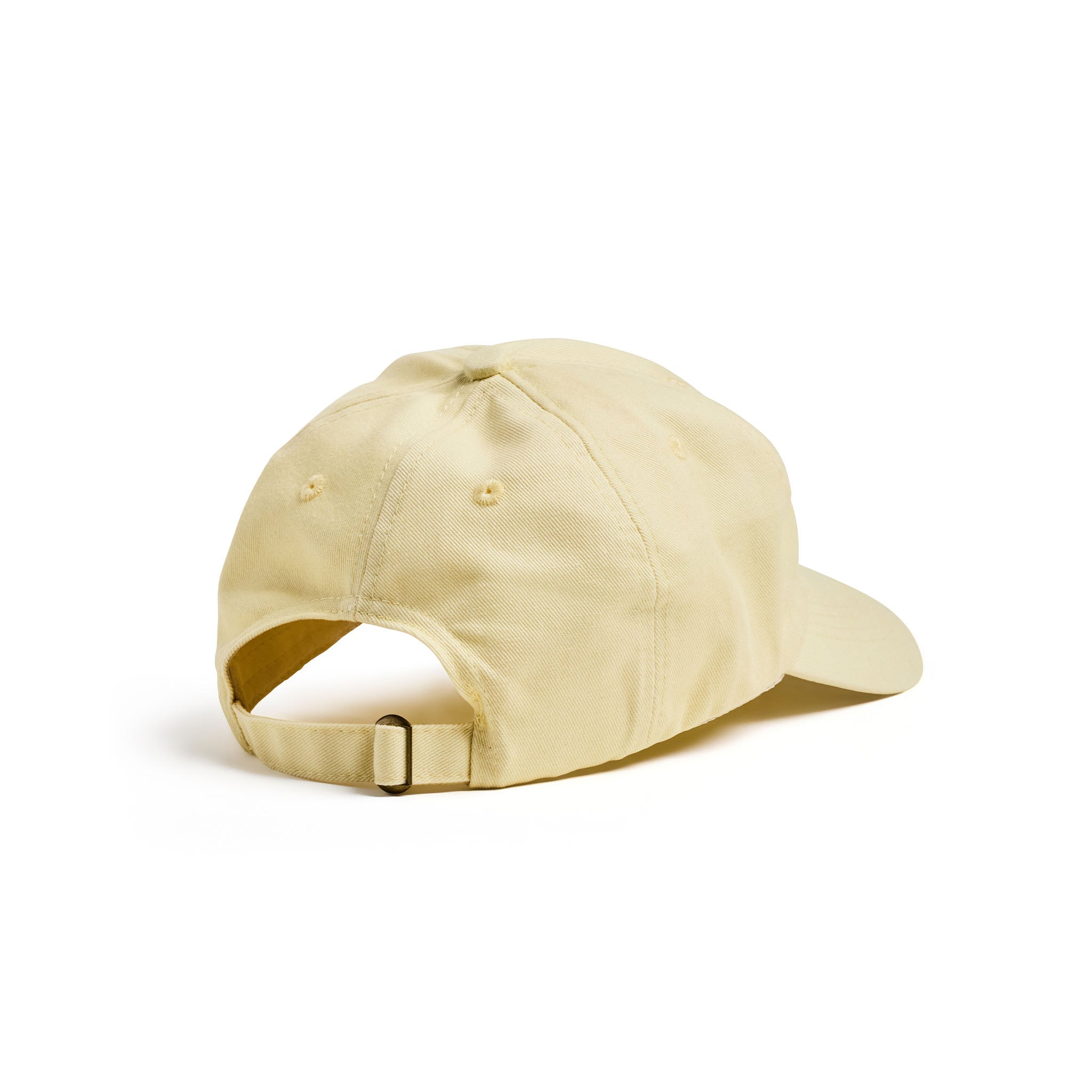 A light beige cap shown from a rear three-quarter angle, featuring an adjustable fabric strap with a small metal buckle, on a solid white background.